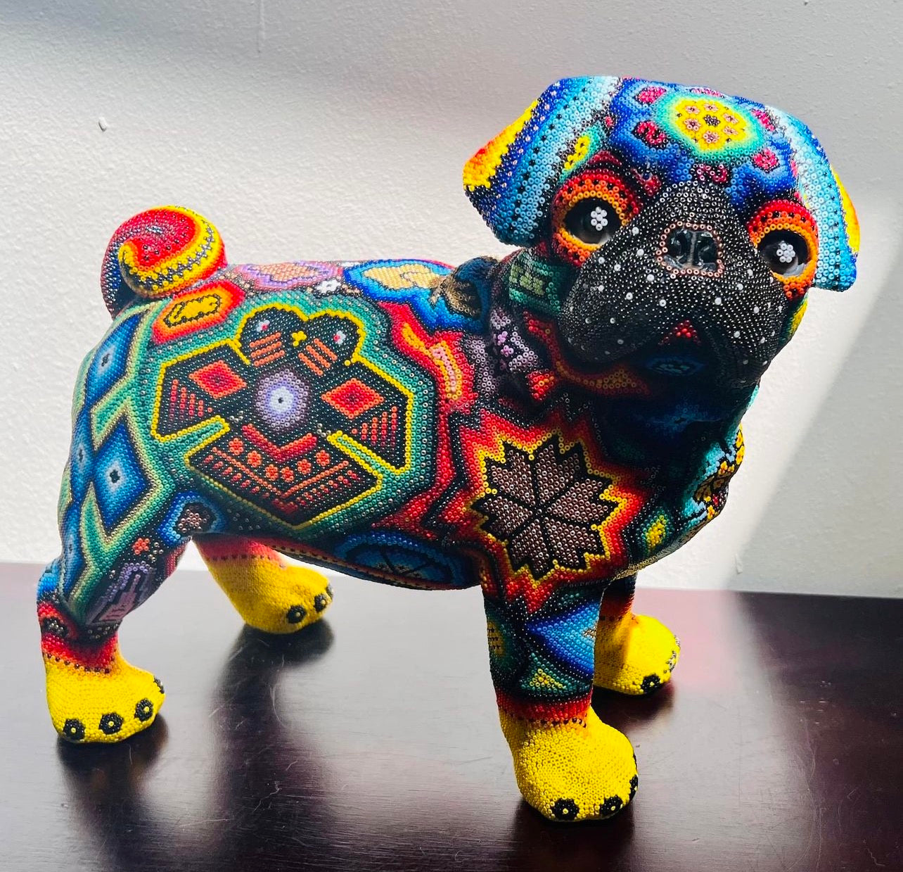 Huichol Pug dog statue lined with tiny beads